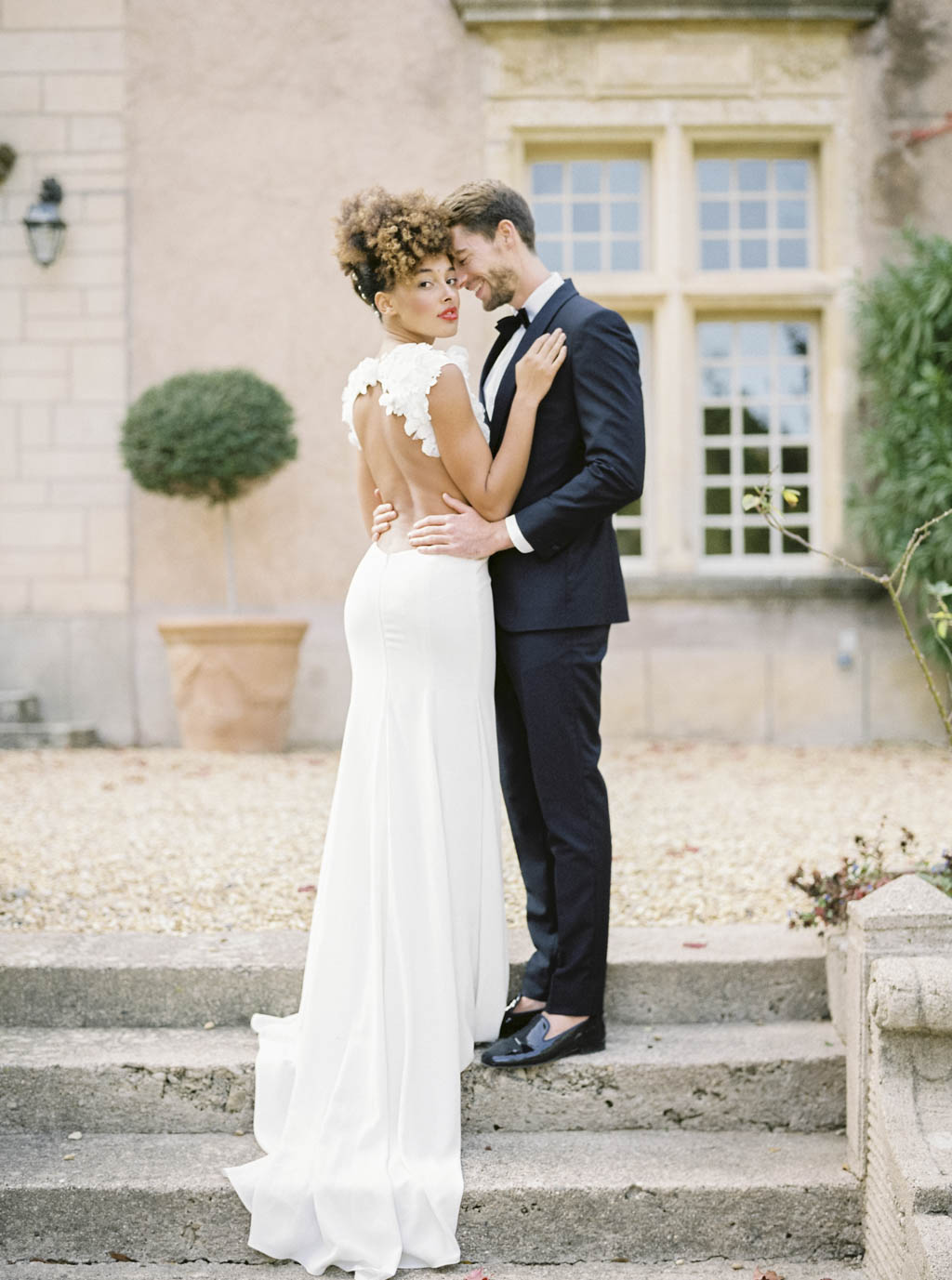Elegant wedding couple at Château Saint-Martin de la Garrigue in the South of France, surrounded by vineyards and golden light.